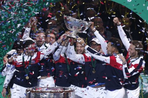The French team holds the cup after France won Davis Cup at the Pierre Mauroy stadium in Lille, northern France, Sunday, Nov. 26, 2017. France won the Davis Cup for the first time in 16 years after beating Belgium 3-2. (AP Photo/Michel Spingler)