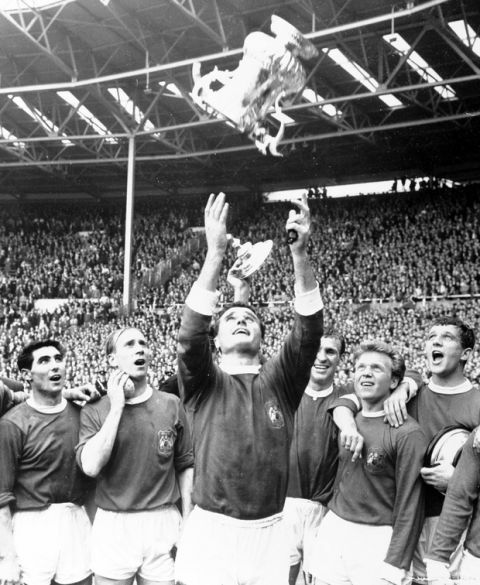 Manchester United team captain Noel Cantwell, centre, throws the FA Cup into the air, at Wembley Stadium, England, May 25, 1963, after Manchester United defeated Leicester City 3-1 in the FA Cup Final. From left to right, Tony Dunne, Bobby Charlton, Cantwell, Pat Crerand, Albert Quixall and David Herd. (AP Photo/Pool)