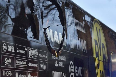 FILE - In this April 11, 2017 file photo, a window of Dortmund's team bus is damaged after an explosion before the Champions League quarterfinal soccer match between Borussia Dortmund and AS Monaco in Dortmund, Germany. A man accused of bombing a German soccer teams bus seven months ago will go on trial Dec. 21, 2017. Borussia Dortmund player Marc Bartra and a police officer were injured when three explosions hit the bus as it left for the team's stadium for a Champions League game on April 11. (AP Photo/Martin Meissner, file)