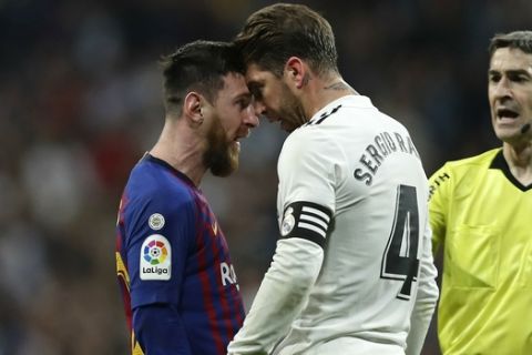 Barcelona forward Lionel Messi, left, goes head to head with Real defender Sergio Ramos after they argue during the Spanish La Liga soccer match between Real Madrid and FC Barcelona at the Bernabeu stadium in Madrid, Saturday, March 2, 2019. (AP Photo/Manu Fernandez)