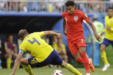 England's Jesse Lingard, right, challenges for the ball with Sweden's Andreas Granqvist, during the quarterfinal match between Sweden and England at the 2018 soccer World Cup in the Samara Arena, in Samara, Russia, Saturday, July 7, 2018. (AP Photo/Matthias Schrader )