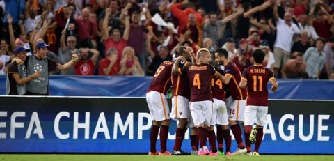 Roma's Italian midfielder Alessandro Florenzi (number 24) celebrates with teammates after scoring against FC Barcelona during the UEFA Champions League football match between AS Roma and FC Barcelona at the Rome Olympic stadium, on September 16, 2015 .           AFP PHOTO / ALBERTO PIZZOLI        (Photo credit should read ALBERTO PIZZOLI/AFP/Getty Images)
