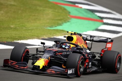 Red Bull driver Alexander Albon of Thailand takes a curve during the third free practice session for the British Formula One Grand Prix at the Silverstone racetrack, Silverstone, England, Saturday, Aug. 1, 2020. The British Formula One Grand Prix will be held on Sunday. (Bryn Lennon/Pool via AP)
