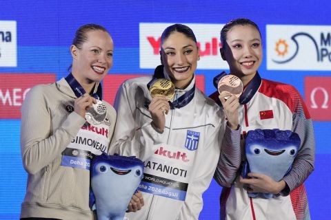 Gold medalist Evangelia Platanioti, of Greece, center, silver medalist Jacqueline Simoneau of Canada, left, and bronze medalist Xu Huiyan of China, pose with their medals after the women's solo technical final of artistic swimming at the World Aquatics Championships in Doha, Qatar, Saturday, Feb. 3, 2024. (AP Photo/Lee Jin-man)