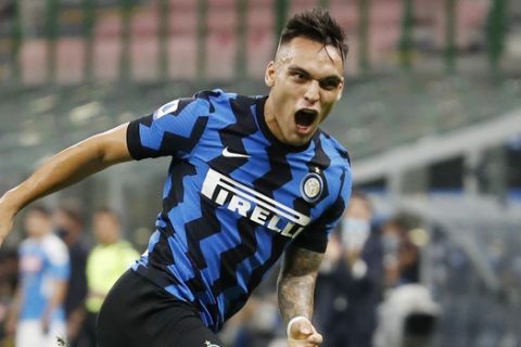 Inter Milan's Lautaro Martinez, right, celebrates after scoring his side's second goal during the Serie A soccer match between Inter Milan and Napoli at the San Siro Stadium, in Milan, Italy, Tuesday, July 28, 2020. (AP Photo/Antonio Calanni)