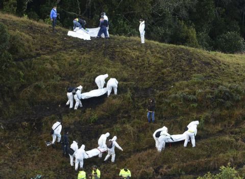 Rescue workers carry the bodies airplane crash victims in a mountainous area near La Union, Colombia, Tuesday, Nov. 29, 2016. The plane was carrying the Brazilian first division soccer club Chapecoense team that was on its way for a Copa Sudamericana final match against Colombia's Atletico Nacional. (AP Photo/Luis Benavides)