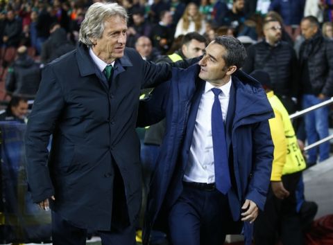 Barcelona coach Ernesto Valverde, right, embraces Sporting coach Jorge Jesus prior the Champions League Group D soccer match between FC Barcelona and Sporting CP at the Camp Nou stadium in Barcelona, Spain, Tuesday, Dec. 5, 2017. (AP Photo/Manu Fernandez)