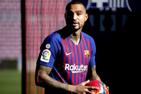 FC Barcelona new signing Kevin-Prince Boateng holds a ball during his presentation at the Camp Nou stadium in Barcelona, Spain, Tuesday, Jan. 22, 2019. Barcelona surprisingly signed Kevin-Prince Boateng on loan from Italian club Sassuolo on Monday until the end of the season. The 31-year-old Boateng has appeared to be past his prime after playing for the likes of AC Milan, Borussia Dortmund, Schalke, and Tottenham. (AP Photo/Emilio Morenatti)