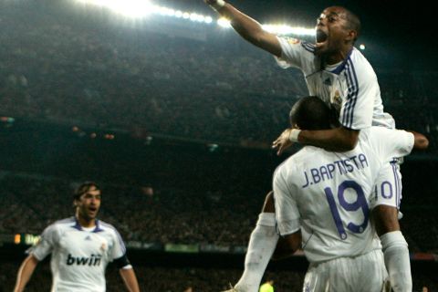 Real Madrid's Julio Baptista, bottom right, from Brazil, is congratulated by fellow team members Raul, left, and Robinho, top right, after scoring against FC Barcelona during their Spanish League soccer match in Barcelona, Spain, Sunday, Dec. 23, 2007. (AP Photo/Bernat Armangue)