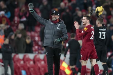 Liverpool's manager Jurgen Klopp waves to supporters after the English Premier League soccer match between Liverpool and Brighton at Anfield Stadium, Liverpool, England, Saturday, Nov. 30, 2019. (AP Photo/Jon Super)