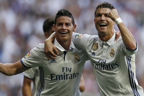 Real Madrid's Cristiano Ronaldo, right, celebrates with teammate James Rodriguez after scoring their side's second goal against Sevilla during the La Liga soccer match between Real Madrid and Sevilla at the Santiago Bernabeu stadium in Madrid, Sunday, May 14, 2017. Ronaldo scored twice in Real Madrid's 4-1 victory. (AP Photo/Francisco Seco)