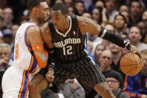 New York Knicks' Jared Jeffries (9) defends Orlando Magic's Dwight Howard (12) during the first half of an NBA basketball game on Wednesday, March 23, 2011, in New York. (AP Photo/Frank Franklin II)
