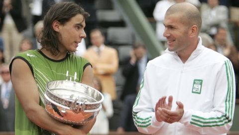 Spain's Rafael Nadal, left, looks at French soccer star Zinedine Zidane after his final match of the French Open tennis tournament, at the Roland Garros stadium, Sunday June 5, 2005 in Paris. Nadal defeated Argentina's Mariano Puerta 6-7 (6), 6-3, 6-1, 7-5. (AP Photo/Michel Euler)