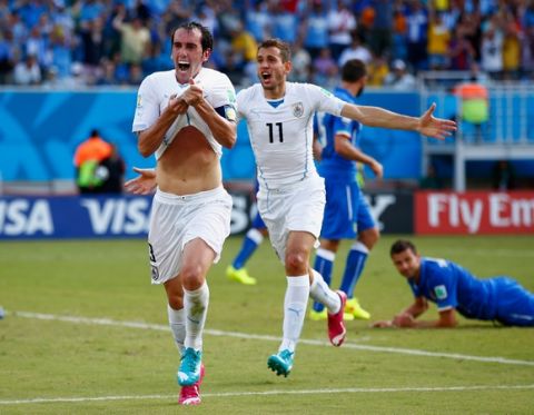 NATAL, BRAZIL - JUNE 24:  Diego Godin of Uruguay (L) celebrates scoring his team's first goal during the 2014 FIFA World Cup Brazil Group D match between Italy and Uruguay at Estadio das Dunas on June 24, 2014 in Natal, Brazil.  (Photo by Clive Rose/Getty Images)