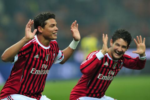 AC Milan's Brazilian defender Thiago Silva (L) celebrates with Brazilian forward Pato after scoring with teammate Swedish forward Zlatan Ibrahimovic and defender Luca Antonini  (R) during their Italian Serie A football match between AC  Milan and Chievo on November 27, 2011 at San Siro  Stadium in Milan. AFP PHOTO / GIUSEPPE CACACE (Photo credit should read GIUSEPPE CACACE/AFP/Getty Images)
