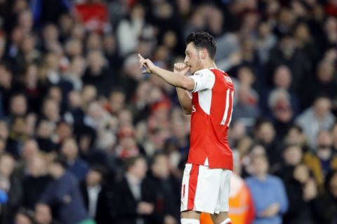 Arsenal's Mesut Ozil celebrates his goal during the English Premier League soccer match between Arsenal and West Ham at the Emirates stadium in London, Wednesday, April 5, 2017.(AP Photo/Frank Augstein)