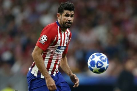 Atletico forward Diego Costa eyes the ball during a Group A Champions League soccer match between Atletico Madrid and Club Brugge at the Wanda Metropolitano stadium in Madrid, Spain, Wednesday Oct. 3, 2018. (AP Photo/Paul White)