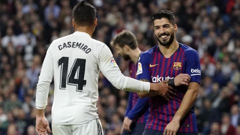 Barcelona forward Luis Suarez, right, smiles as Real midfielder Casemiro touches him during the Spanish La Liga soccer match between Real Madrid and FC Barcelona at the Bernabeu stadium in Madrid, Saturday, March 2, 2019. (AP Photo/Andrea Comas)