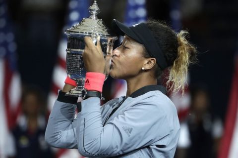 Naomi Osaka, of Japan, kisses the trophy after defeating Serena Williams in the women's final of the U.S. Open tennis tournament, Saturday, Sept. 8, 2018, in New York. (AP Photo/Julio Cortez)