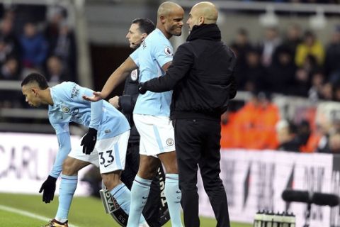 Manchester City's Vincent Kompany, center, comes off the pitch after picking up an injury during their English Premier League soccer match against Newcastle United at St James' Park, Newcastle, England, Wednesday, Dec. 27, 2017. (Owen Humphreys/PA via AP)