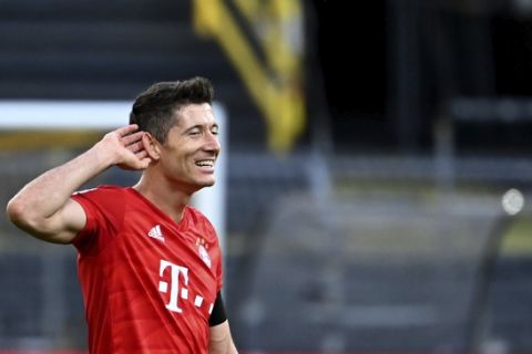 Munich's Robert Lewandowski reacts after the German Bundesliga soccer match between Borussia Dortmund and FC Bayern Munich in Dortmund, Germany, Tuesday, May 26, 2020. The German Bundesliga is the world's first major soccer league to resume after a two-month suspension because of the coronavirus pandemic. (Federico Gambarini/DPA via AP, Pool)