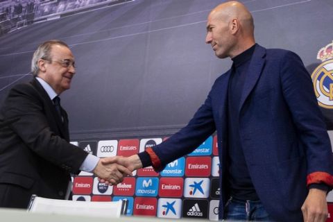 Zinedine Zidane shakes hands with President of Real Madrid, Florentino Perez, during a press conference in Madrid, Spain, Thursday, May 31, 2018. Zinedine Zidane quit as Real Madrid coach on Thursday, less than a week after leading the team to its third straight Champions League title, saying the club needed a change in command. (AP Photo/Borja B. Hojas)
