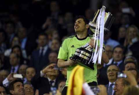 Real Madrid's goalkeeper Iker Casillas celebrates with the trophy at the end of the Spanish Copa del Rey (King's Cup) final "Clasico" football match FC Barcelona vs Real Madrid CF at the Mestalla stadium in Valencia on April 16, 2014. Real Madrid won 2-1.  AFP PHOTO/ LLUIS GENE        (Photo credit should read LLUIS GENE/AFP/Getty Images)