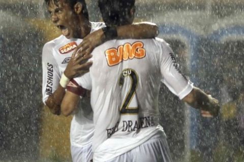 Edu Dracena (R) of Brazil's Santos celebrates with his teammate Neymar after scoring against Peru's Juan Aurich during their Copa Libertadores soccer match in Sao Paulo March 22, 2012. REUTERS/Paulo Whitaker (BRAZIL - Tags: SPORT SOCCER)