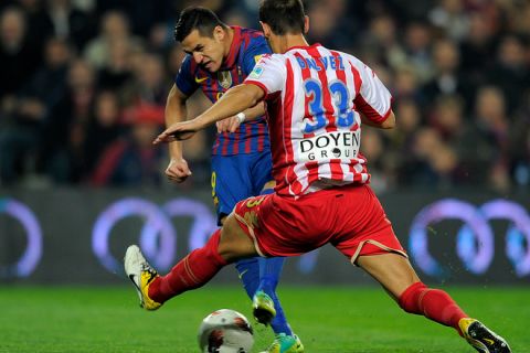 Barcelona forward Alexis Alejandro Sanchez (L) of Chile fights for the ball with Sporting Gijon defender Mendy (R) on March 3, 2012 during a Spanish league football match at the Camp Nou stadium in Barcelona. AFP PHOTO/LLUIS GENE (Photo credit should read LLUIS GENE/AFP/Getty Images)