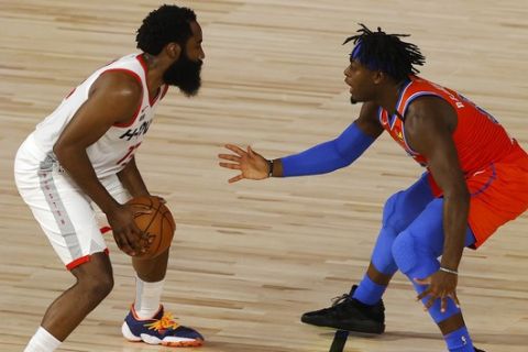 Houston Rockets' James Harden, left, drives against Oklahoma City Thunder's Luguentz Dort, right, during the second quarter of Game 3 of an NBA basketball first-round playoff series, Saturday, Aug. 22, 2020, in Lake Buena Vista, Fla. (Mike Ehrmann/Pool Photo via AP)