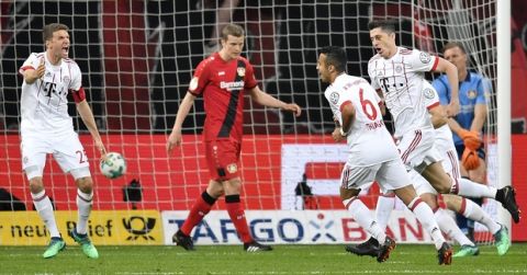 Bayern's Thomas Mueller, left, reacts after Bayern's Robert Lewandowski, right, scored his side's second goal during the German soccer cup semifinal match between Bayer Leverkusen and Bayern Munich in Leverkusen, Germany, Tuesday, April 17, 2018. (AP Photo/Martin Meissner)