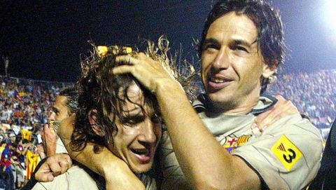 Barcelonas Carles Pujol, left and Demetrio Albertini of Italy celebrate after Barcelona won the Spanish league title in the Ciudad de Valencia stadium in Valencia, Spain Saturday May 14, 2005. The game against Levente ended in a 1-1 draw with Barcelona  clinching the  league title. (AP Photo/Fernando Bustamante)