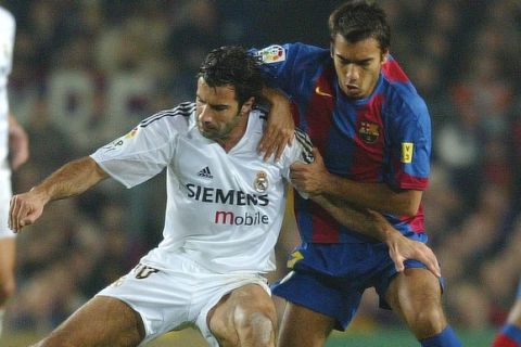 FC Barcelona player Oleguer Presas, right, duels for the ball against Real Madrid player Luis Figo, from Portugal, during their league soccer match in Barcelona, Spain, Saturday, Nov. 20, 2004. FC Barcelona won the match 3-0. (AP Photo/Bernat Armangue)
