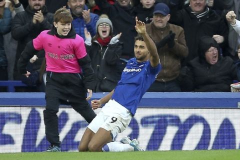 Everton's Mason Holgate celebrates scoring his side's second goal of the game, during the English Premier League soccer match between Everton and Liverpool at Goodison Park, in Liverpool, England, Saturday, Dec. 7, 2019. (Nigel French/PA via AP)