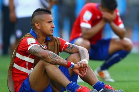 BELO HORIZONTE, BRAZIL - JUNE 28:  Arturo Vidal of Chile looks dejected after being defeated by Brazil in the penatly shootout during the 2014 FIFA World Cup Brazil round of 16 match between Brazil and Chile at Estadio Mineirao on June 28, 2014 in Belo Horizonte, Brazil.  (Photo by Paul Gilham/Getty Images)