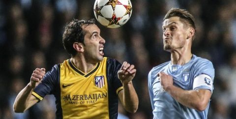 Atletico's Diego Godin (L) and Malmo's Markus Rosenberg vie for the ball during the UEFA Champions League Group A football match Malmo FF vs Club Atletico de Madrid in Malmo, Sweden on November 4, 2014 . AFP PHOTO / Andreas HILLERGEN  ==SWEDEN OUT==        (Photo credit should read ANDREAS HILLERGREN/AFP/Getty Images)