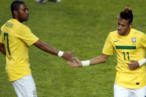 Brazil's Neymar, right, is greeted by teammate Robinho while leaving the field during his substitution in the Copa America quarterfinal soccer match against Paraguay in La Plata, Argentina, Sunday, July 17, 2011. Neymar was replaced by Fred. (AP Photo/Fernando Vergara)