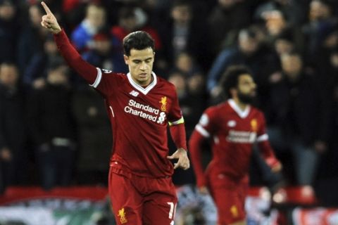 Liverpool's Philippe Coutinho, left, celebrates after scoring his side's second goal during the Champions League Group E soccer match between Liverpool and Spartak Moscow at Anfield, Liverpool, England, Wednesday, Dec. 6, 2017. (AP Photo/Rui Vieira)