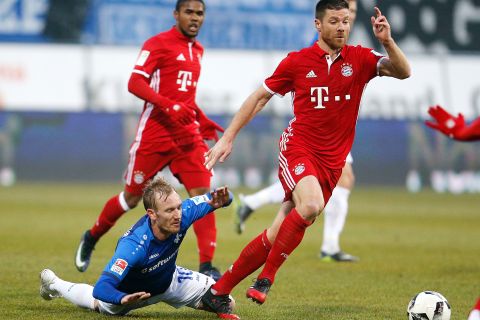Darmstadt's Jan Rosenthal, left, and Bayern's Xabi Alonso challenge for the ball during a German first division Bundesliga soccer match between Darmstadt 98 and Bayern Munich in Darmstadt, Germany, Sunday, Dec. 18, 2016. (AP Photo/Michael Probst)