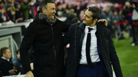 Barcelona's manager Luis Enrique, left smiles beside Athletic Bilbao's manager Ernesto Valverde, during the Spanish Copa del Rey, 16 round, first leg soccer match, between FC Barcelona and Athletic Bilbao, at San Mames stadium, in Bilbao, northern Spain, Thursday, Jan.5, 2017. FC Barcelona lost the match 2-1. (AP Photo/Alvaro Barrientos)