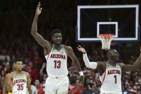 Arizona's Deandre Ayton (13) and Rawle Alkins (1) celebrate during the final seconds of their 84-78 victory over 3rd ranked Arizona State during an NCAA college basketball game, Saturday, Dec. 30, 2017, in Tucson, Ariz. (AP Photo/Ralph Freso)