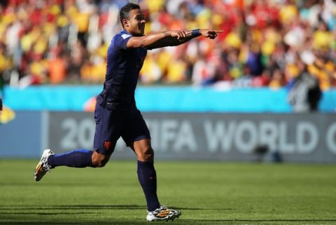 PORTO ALEGRE, BRAZIL - JUNE 18: Memphis Depay of the Netherlands celebrates scoring his team's third goal during the 2014 FIFA World Cup Brazil Group B match between Australia and Netherlands at Estadio Beira-Rio on June 18, 2014 in Porto Alegre, Brazil.  (Photo by Dean Mouhtaropoulos/Getty Images)