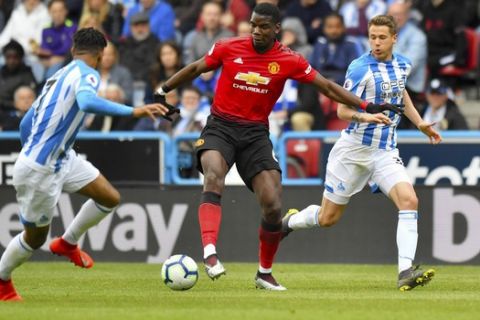 Manchester United's Paul Pogba in action during the English Premier League soccer match against Huddersfield Town at the John Smith's Stadium, Huddersfield, England, Sunday May 5, 2019. (Anthony Devlin/PA via AP)