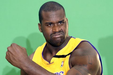 Los Angeles Lakers center Shaquille O'Neal flexes his muscle during a television promo at media day Monday, Sept. 30, 2002, at the Lakers training facility in El Segundo, Calif.  (AP Photo/Kevork Djansezian)