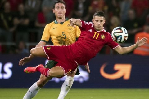 Belgium's Kevin Mirallas, front, jumps for the ball in front of Australia's Mark Milligan during a friendly soccer match at the Maurice Dufrasne station in Liege, Belgium on Thursday Sept. 4, 2014. (AP Photo/Geert Vanden Wijngaert)