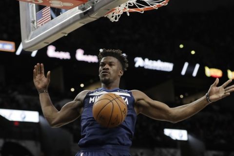 Minnesota Timberwolves guard Jimmy Butler (23) scores against the San Antonio Spurs during the first half of an NBA basketball game, Wednesday, Oct. 17, 2018, in San Antonio. (AP Photo/Eric Gay)