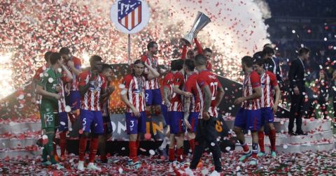 Atletico players celebrate with the trophy after winning the Europa League Final soccer match between Marseille and Atletico Madrid at the Stade de Lyon in Decines, outside Lyon, France, Wednesday, May 16, 2018. (AP Photo/Francois Mori)