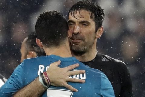 Juventus goalkeeper Gianluigi Buffon, right, hugs Real Madrid's Cristiano Ronaldo after the Champions League, round of 8, first-leg soccer match between Juventus and Real Madrid at the Allianz stadium in Turin, Italy, Tuesday, April 3, 2018. Real won 3-0. (AP Photo/Luca Bruno)
