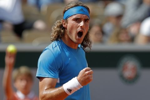 Greece's Stefanos Tsitsipas clenches his fist after scoring a point against Bolivia's Hugo Dellien during their second round match of the French Open tennis tournament at the Roland Garros stadium in Paris, Wednesday, May 29, 2019. (AP Photo/Pavel Golovkin)