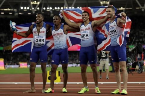 From left, Britain's Nethaneel Mitchell-Blake, Chijindu Ujah, Adam Gemili and Daniel Talbot celebrate after winning a gold medal in the men's 4x100-meter relay final during the World Athletics Championships in London Saturday, Aug. 12, 2017. (AP Photo/Matt Dunham)